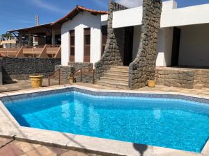 a swimming pool in front of a house at Conceitual Hostel Natal in Natal