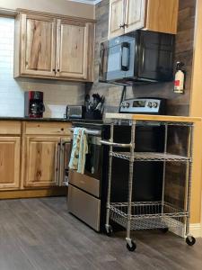 a kitchen with wooden cabinets and a stove top oven at Relaxing River Family Retreat in Bullhead City