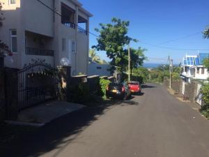 a street with a car parked next to a building at Villa Anastasia in Flic-en-Flac
