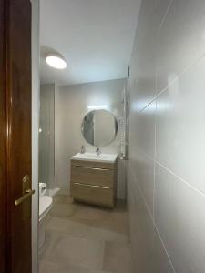 a bathroom with a sink and a mirror at Puerta del Hierro in Sigüenza