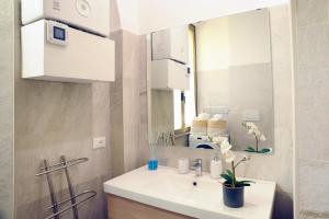 a bathroom with a sink and a mirror at Home Vaticano 50 steps from Museum in Rome +41 photos