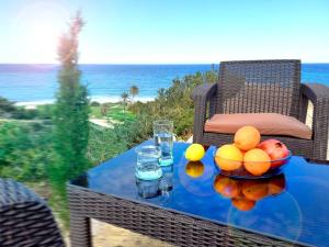 a table with a bowl of fruit on top at Boutique seafront apartment in Saint Amvrosios