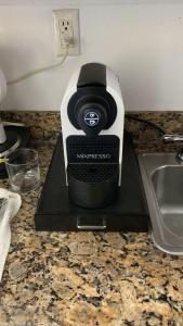 a blender sitting on a counter next to a sink at Ramada Marco Polo Beach in Miami Beach