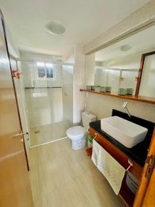 a bathroom with a sink and a toilet at Aloha Vibes Ap Cumbuco -Beach Place in Cumbuco
