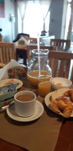 a table topped with plates of food and orange juice at Hotel Costanera in Formosa