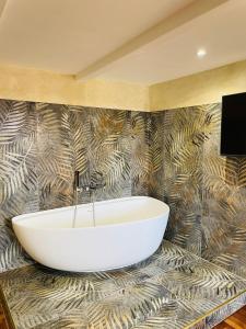 a bathroom with a bath tub on a wall at Excellence Suite in Rome