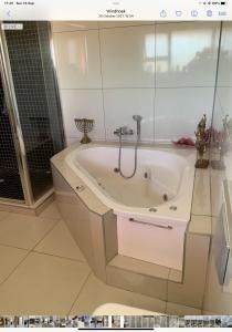 a bathroom with a bath tub in a room at Almina villa in Windhoek