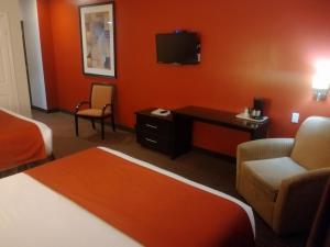 イダルゴ・デル・パラルにあるHotel La Mina Parralのベッド2台とテレビが備わるホテルルームです。