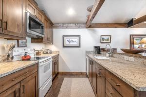 uma cozinha com armários de madeira e electrodomésticos brancos em Golf Creek 31 em Jackson