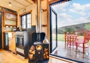 a kitchen with a stove and a deck with a table at The Orient Express in Cray