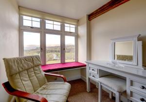 a room with a desk and a chair and a window at Rhiwlas in Pennal