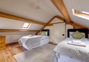 a bedroom with two beds in a attic at Rhiwlas in Pennal