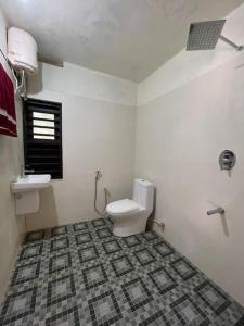 a bathroom with a toilet and a sink at Deesha Homes in Wayanad