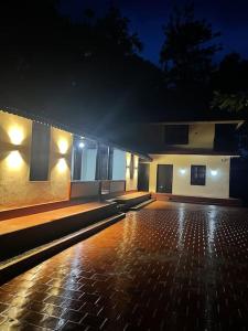 a building with a lit up courtyard at night at Deesha Homes in Wayanad