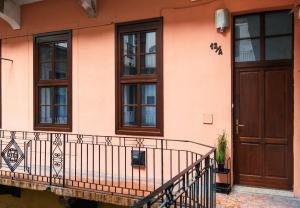 a house with a balcony and a wooden door at Erika's Downtown Home Budapest in Budapest