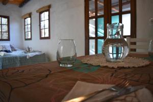 una mesa con un jarrón de cristal y un tenedor y un cuchillo en Luz de Cabaña en Carpintería