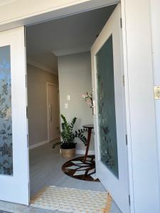 an open door into a room with a table at Bouganville Guest House BC in Balneário Camboriú