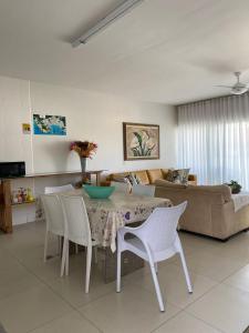 sala de estar con mesa, sillas y sofá en Bouganville Guest House BC, en Balneário Camboriú