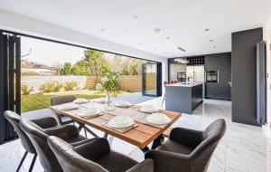 a kitchen and dining room with a table and chairs at Luxury 7 Bedroom House in Didsbury, Manchester in Manchester
