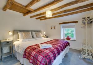 a bedroom with a large bed with a colorful blanket at Gellilwyd Fach in Dolgellau