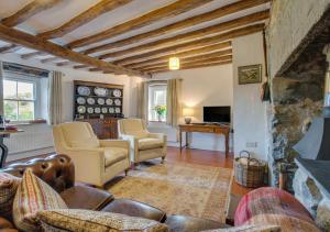 a living room with a couch and a fireplace at Gellilwyd Fach in Dolgellau