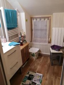 uma pequena cozinha com um lavatório e uma janela em Maison cocoon et chaleureuse 