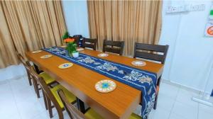 a dining room table with a blue and white table cloth at Kota Kinabalu Sabah City Homestay in Kota Kinabalu