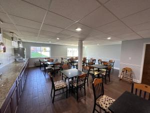 a restaurant with tables and chairs and a counter at I65 Studio Suites in Scottsburg