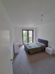 a white room with a bed and a window at ExCel London - Fantastic Garden - 3 Bedroom-Condo in Beckton