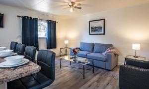 a living room with a couch and a table at Downie Cottage by Revelstoke Vacations in Revelstoke +21 photos