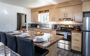 a kitchen with a large island with a table and chairs at Downie Cottage by Revelstoke Vacations in Revelstoke