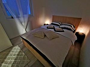 a large bed in a bedroom with a window at GOLDEN - self CHECK IN in Osijek