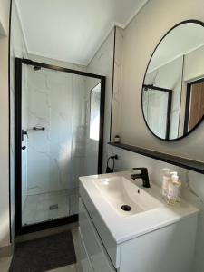 a bathroom with a sink and a mirror at Penthouse in Waterfall with backup power in Midrand