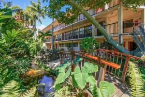 an apartment building with a walkway and a pond in front at Prince Kuhio 319 in Koloa