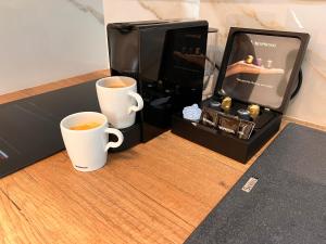 twee kopjes koffie bovenop een tafel bij Ski Suites - Family Maisonette Kalavryta in Kalavrita