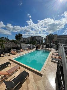 a swimming pool with chaise lounge chairs on a building at Holiday Isles Resort in St Pete Beach