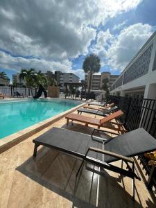 a group of picnic tables sitting next to a swimming pool at Holiday Isles Resort in St Pete Beach