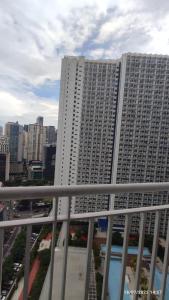 a large white building with a city in the background at Jazz Residences (Destina Stays)Makati, Metro Manila in Manila