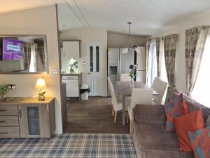a living room with a couch and a dining room at Bock Retreat Lodge 54 with Hot Tub in Felton