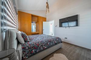 a bedroom with a bed and a tv in it at Dene Hollow in Voroklini