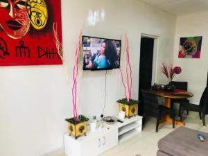 a living room with a tv on a wall at Serenity in Accra