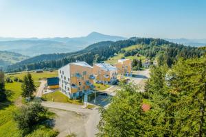 an aerial view of a building with mountains in the background at Apartmán Hillside Panorama in Dolný Kubín