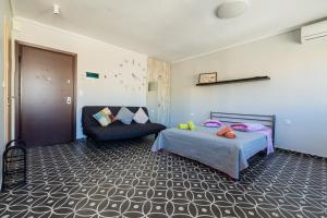 een slaapkamer met een bed en een stoel bij Modiano Studio Ι By Socrates Junior Houses in Thessaloniki