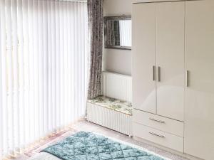 a room with a white cabinet and a rug at Moor View in Newton Abbot