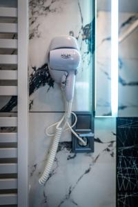 a blow dryer on a wall in a bathroom at Villa Balos in Gronków