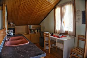 a kitchen with a sink and a counter top at Wooden Sofita House with Unlimited View in Grevena
