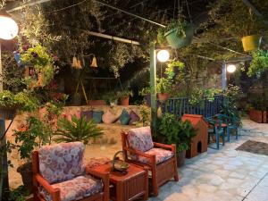 a patio with chairs and a table and plants at بيت الطبيعة nature house in Jerash