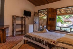 1 dormitorio con cama y ventana en Pousada Capitão Gancho, en Barra Grande