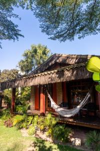 a house with a hammock in front of it at Pousada Capitão Gancho in Barra Grande