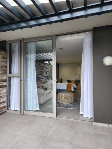 a room with sliding glass doors and a bedroom at Sugar Shores - Studio Apartment in Sibaya